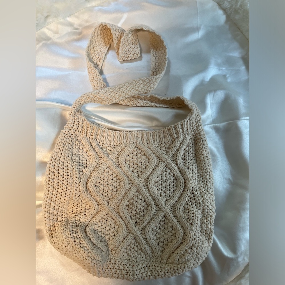 Cream colored tote bag with size reference and snap button.